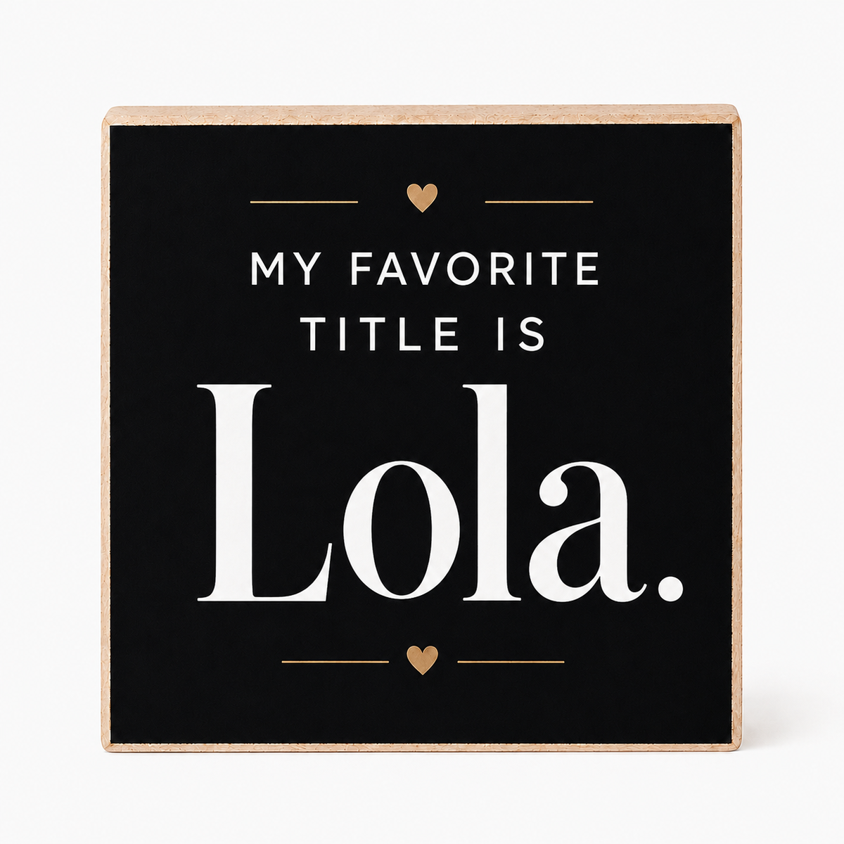 A square decorative sign with a black face and natural wood border, reading “MY FAVORITE TITLE IS Lola.” in white text with small gold heart and line accents, shown on a light gray background.