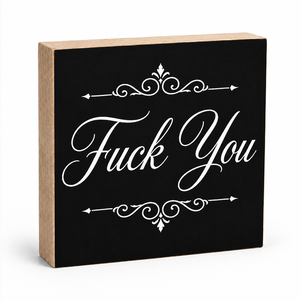 A square decorative wooden sign with a black front panel and natural wood sides, featuring the phrase 'Fuck You' in large white script with ornamental flourishes above and below, shown on a white background.