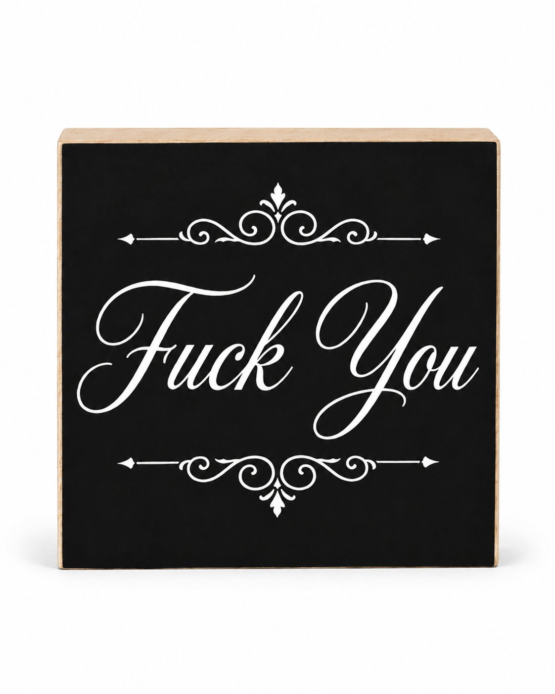 A square decorative wooden sign with a black front panel and natural wood edges, featuring the phrase 'Fuck You' in large white script with ornamental flourishes above and below, shown on a white background.