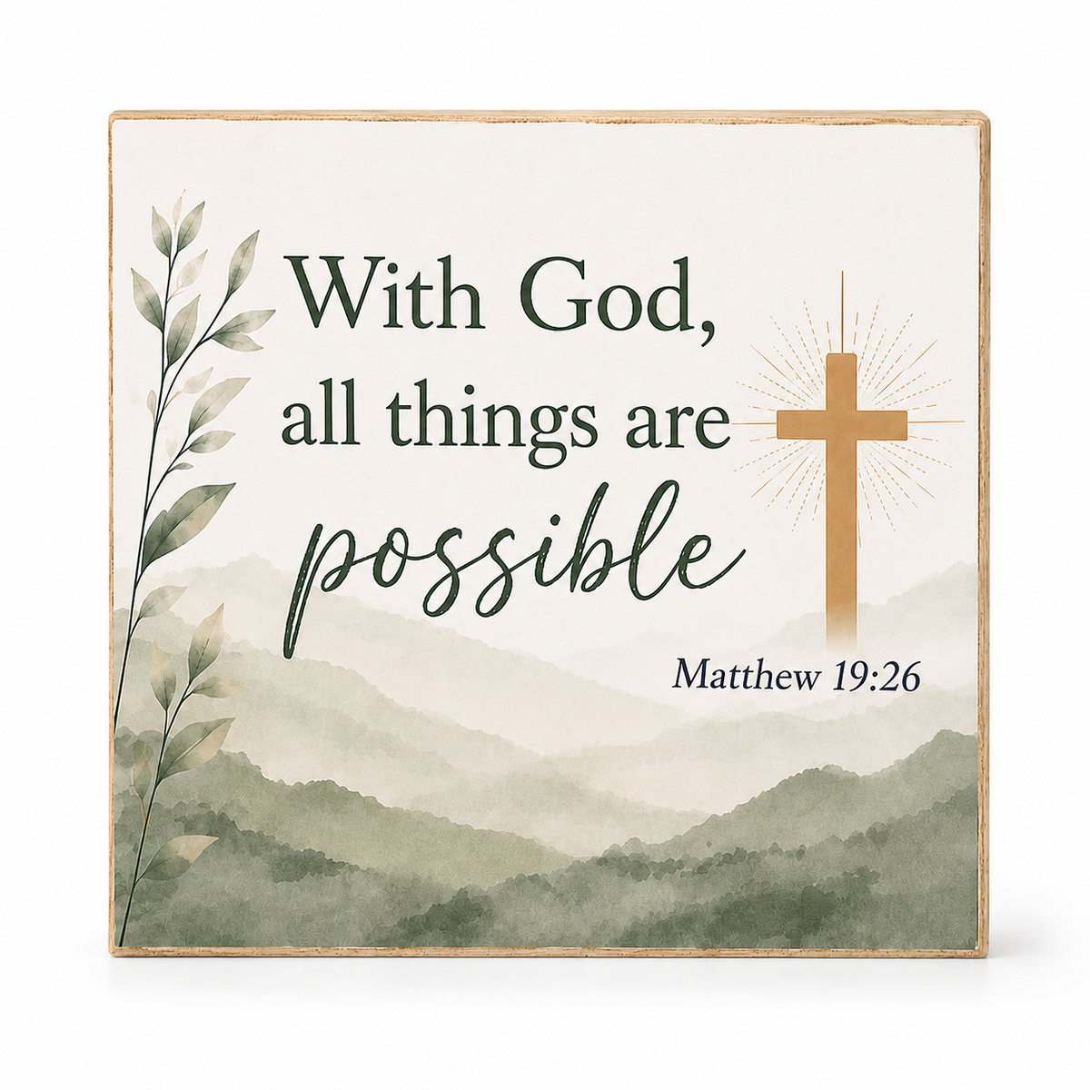 Square decorative wall plaque with a watercolor mountain landscape, the phrase “With God, all things are possible,” a gold cross with rays, and “Matthew 19:26” in dark green text on a light background.
