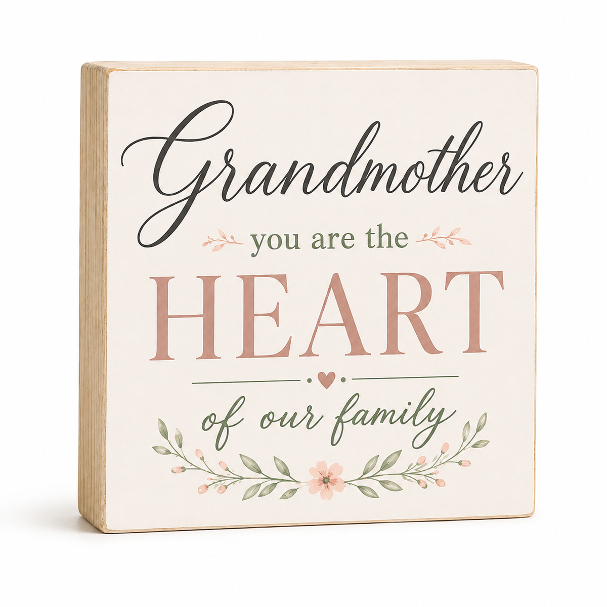 A square decorative wooden sign with a cream face and natural wood edges, printed with the phrase 'Grandmother you are the HEART of our family' in black and dusty pink lettering, with small floral and leaf illustrations, on a white background.