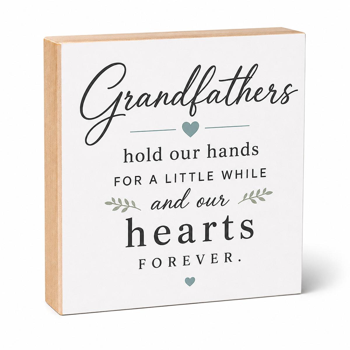 A square wooden sign with a white front and natural wood sides, featuring the printed message 'Grandfathers hold our hands for a little while and our hearts FOREVER' in black lettering with small teal heart and leaf accents, shown on a white background.