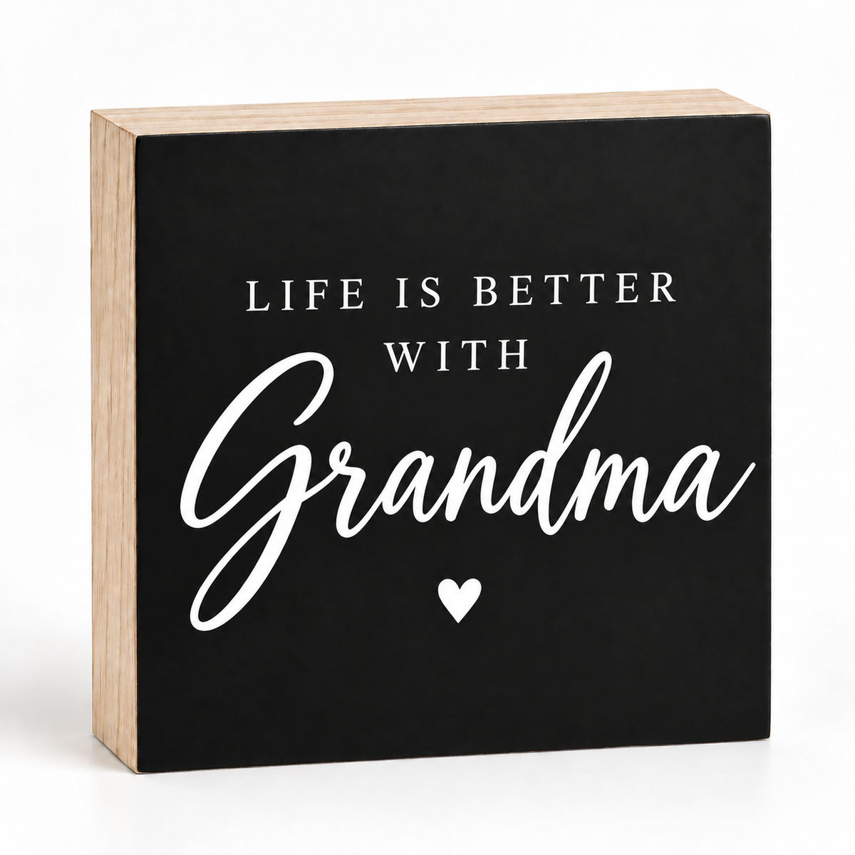 A square decorative wooden sign with a black front panel and natural wood sides. The sign reads “LIFE IS BETTER WITH Grandma” in white lettering, with a small white heart below the word “Grandma,” on a clean white background.