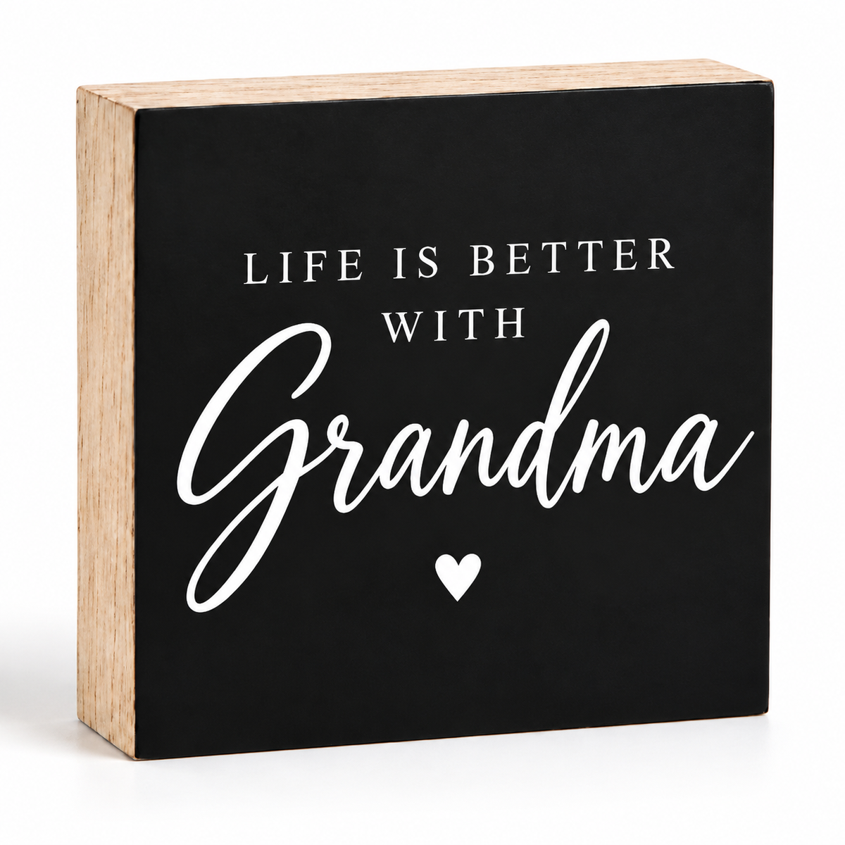 A square decorative block sign with a black front panel and natural wood sides. The front reads “LIFE IS BETTER WITH Grandma” in white text, with “Grandma” in large script and a small white heart below.