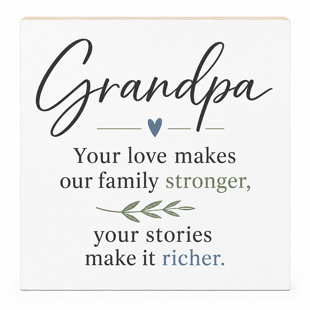 Square white decorative sign with a light wood edge, featuring the word 'Grandpa' in large black script and a family message in black, muted green, and blue text with small heart and leaf illustrations.