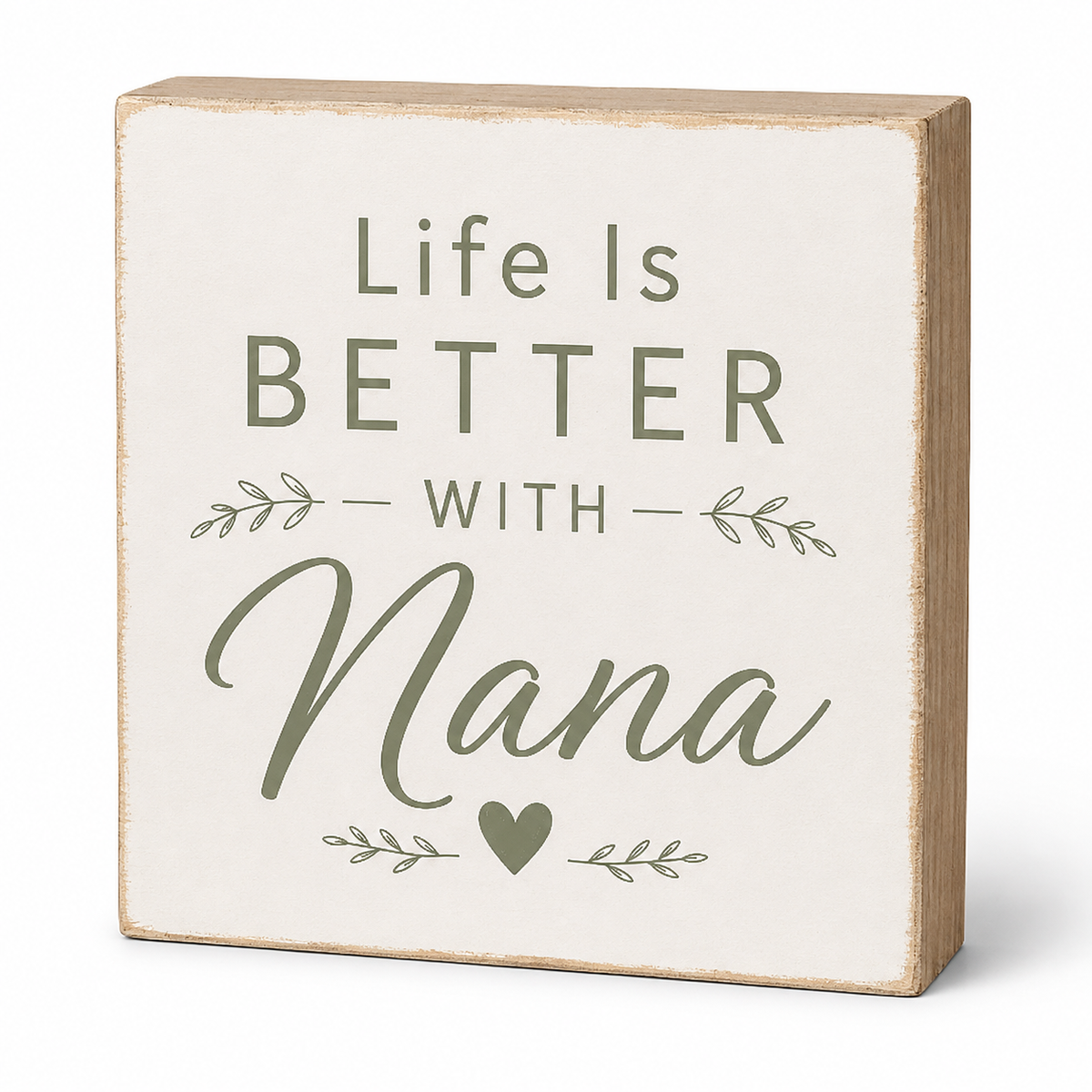 A square decorative wooden sign with a distressed cream face and natural wood edges. The sign features the text 'Life Is BETTER WITH Nana' in muted sage green lettering, accented with small leafy branches and a heart.