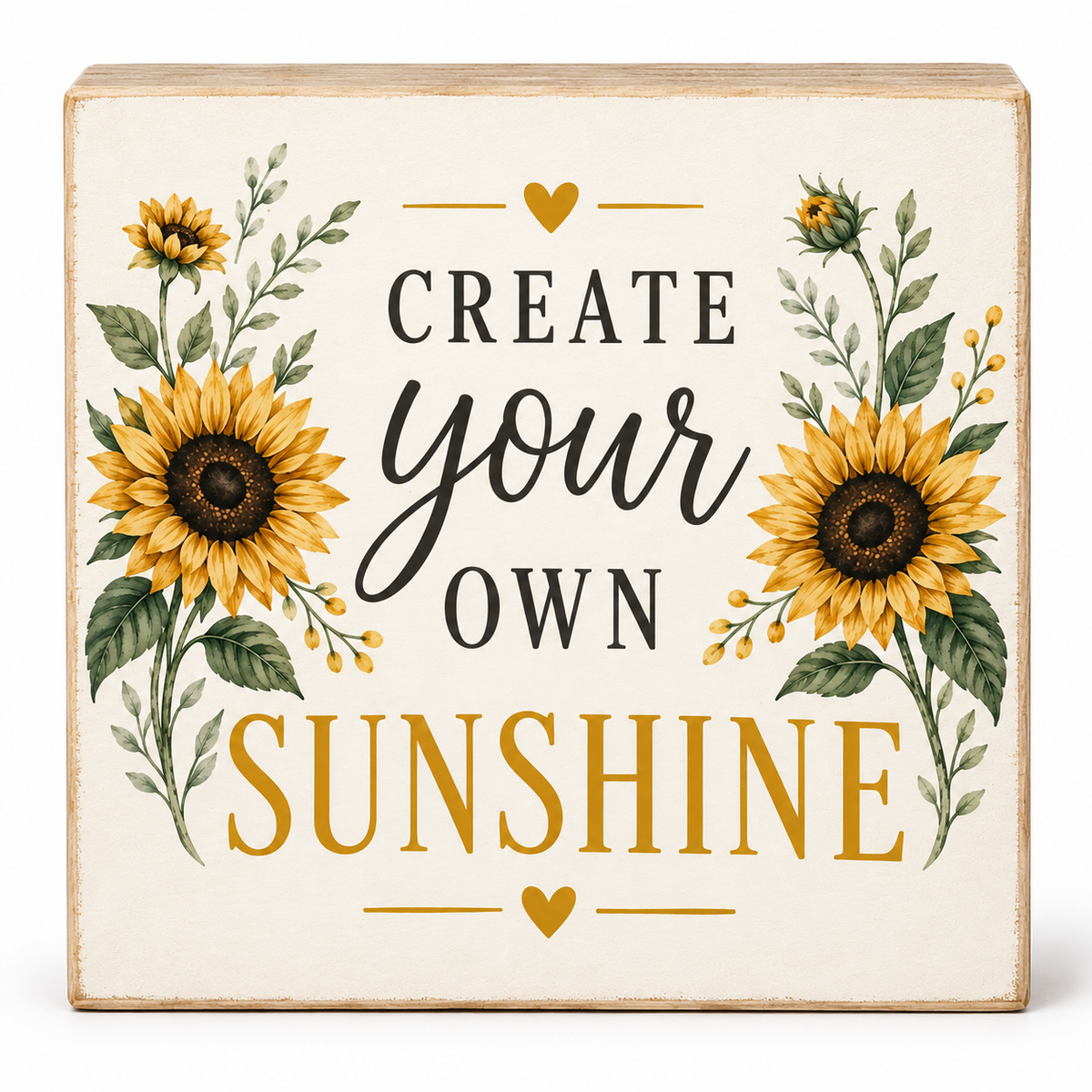 A square decorative wooden sign with a distressed cream background, featuring the phrase 'CREATE your OWN SUNSHINE' in black and mustard lettering, surrounded by illustrated sunflowers and green leaves.