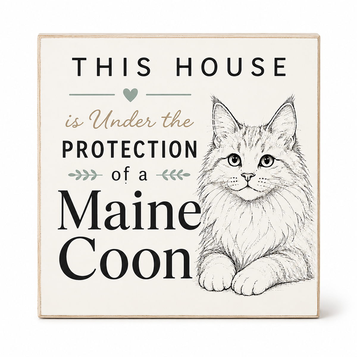 Square decorative wall sign with a light wood border, cream background, and printed text reading 'THIS HOUSE is Under the PROTECTION of a Maine Coon' alongside a detailed black-and-white illustration of a Maine Coon cat.