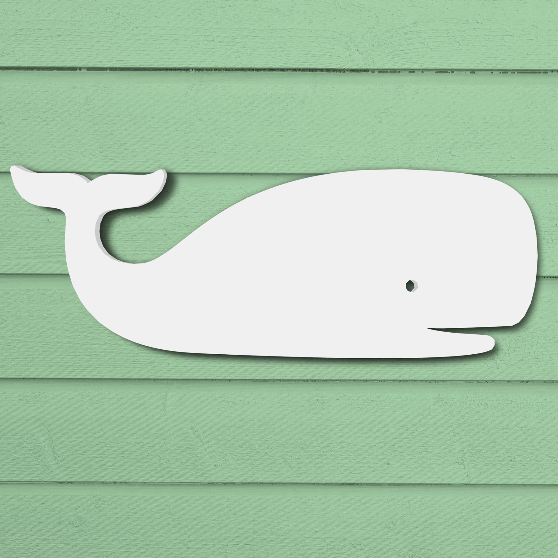 Durable white PVC whale silhouette wall art for outdoor coastal home decor with a green wood background.