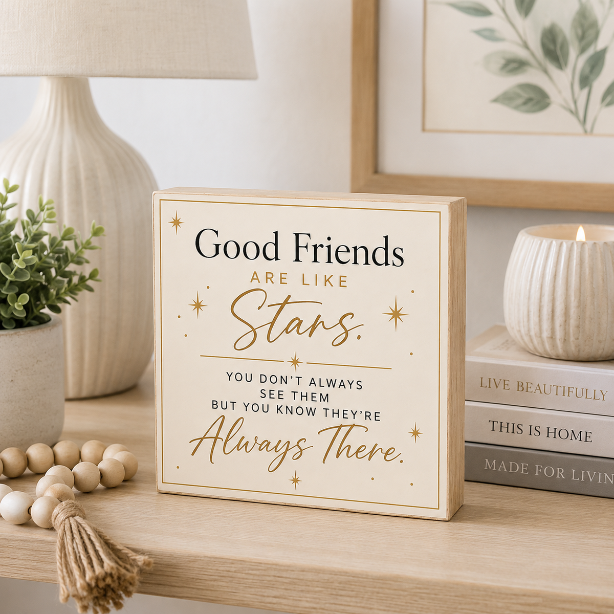 A square wooden sign with a cream background and gold lettering that reads, 'Good Friends ARE LIKE Stars. YOU DON'T ALWAYS SEE THEM BUT YOU KNOW THEY'RE Always There.