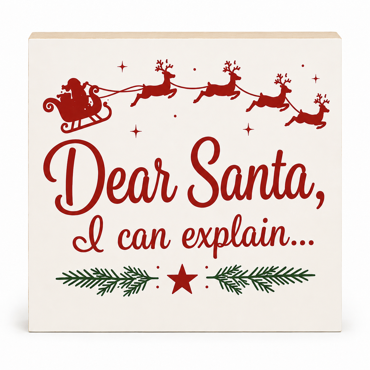 A square decorative sign with a cream background featuring red text that reads 'Dear Santa, I can explain.
