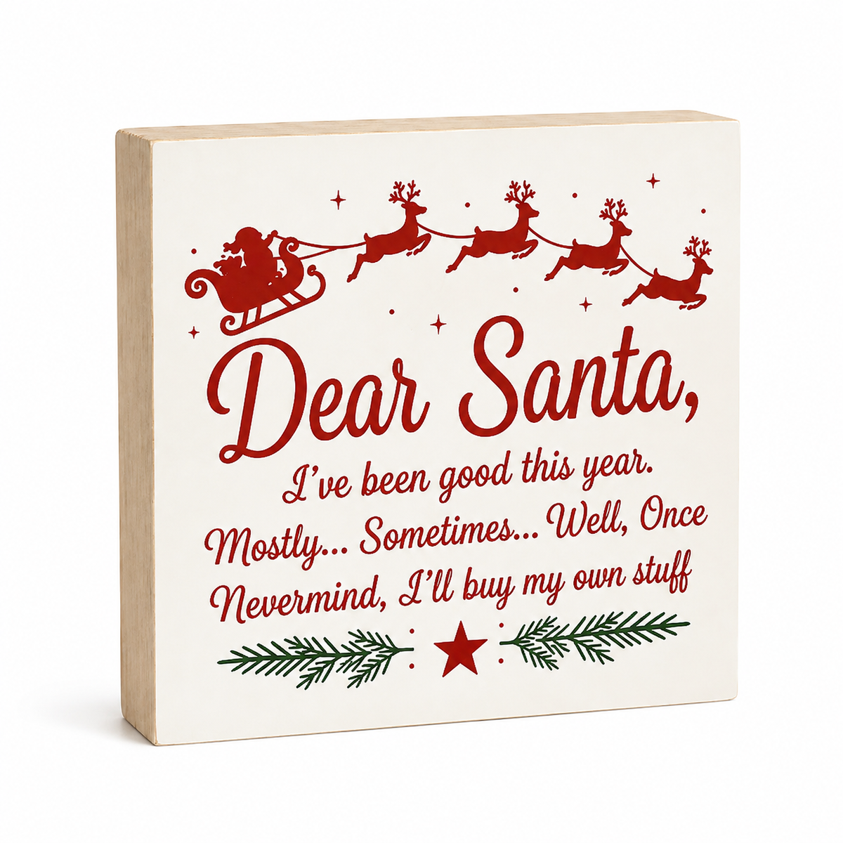 A square decorative wooden sign with a light natural wood edge and a cream face, printed with a red Santa Claus sleigh and reindeer silhouette above the phrase “Dear Santa,” followed by a humorous Christmas message in red script and serif fonts, and a green pine branch motif with a red star near the bottom.