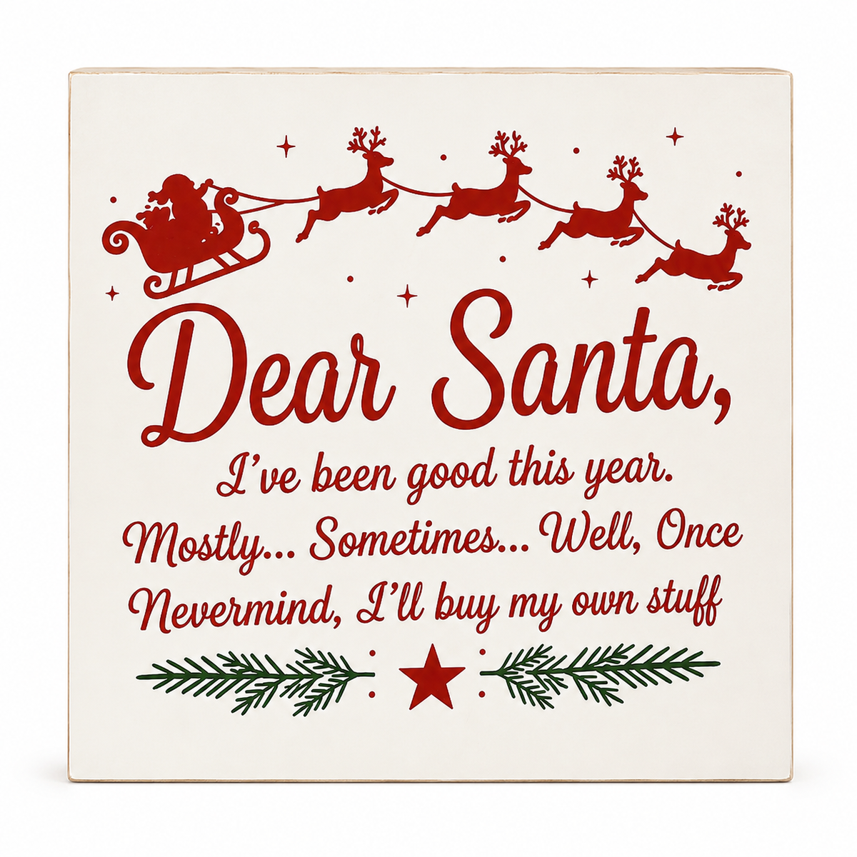 A square decorative sign with a cream background and red printed holiday text reading 'Dear Santa, I've been good this year. Mostly.