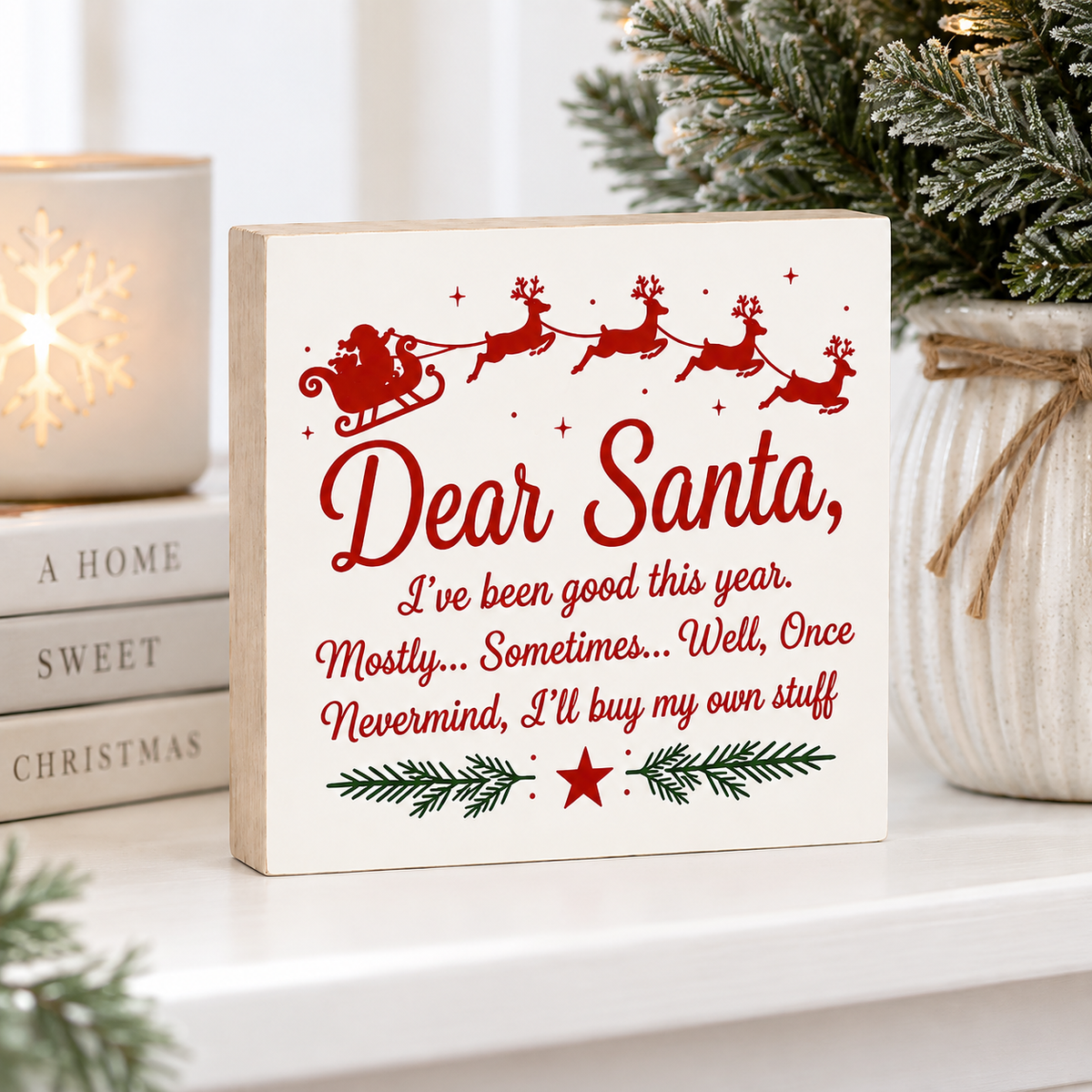 A square wooden Christmas sign with red text reading 'Dear Santa, I've been good this year.