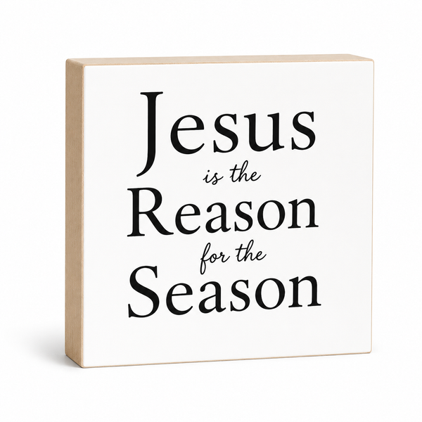 Wooden block with 'Jesus is the Reason for the Season' text on a white background