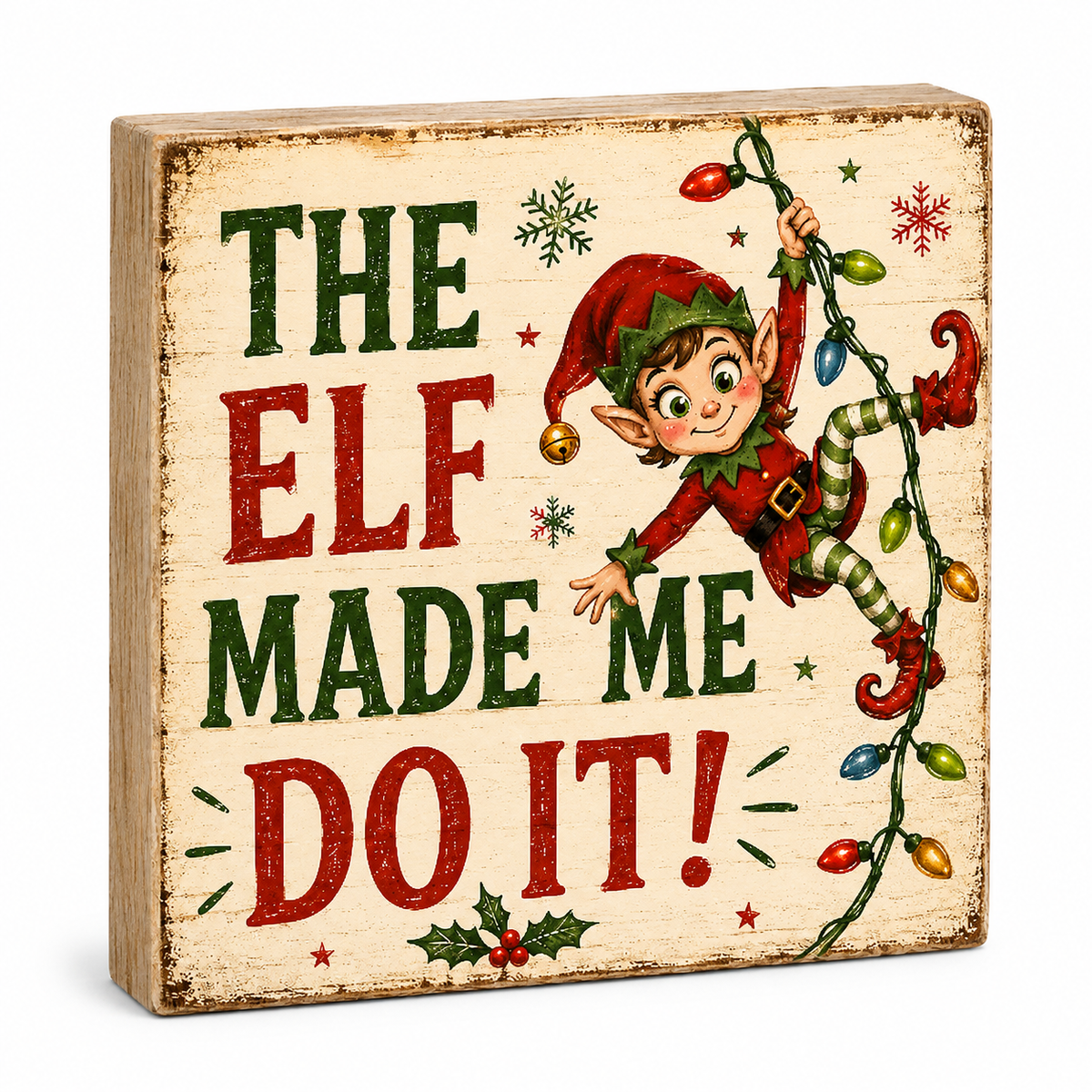 A square wooden Christmas sign with a distressed cream background, featuring the text 'THE ELF MADE ME DO IT!' in red and green lettering, alongside an illustration of a smiling elf climbing a string of multicolored holiday lights.