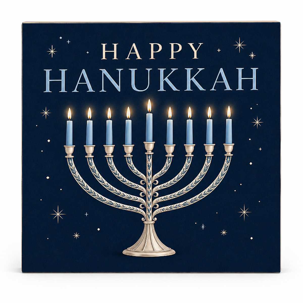 Square decorative wall art or sign featuring a Hanukkah menorah with nine lit blue candles on a dark navy background, with the words “HAPPY HANUKKAH” in light blue and gold star accents.