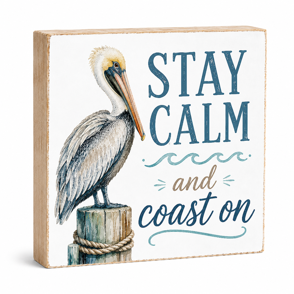 A square decorative wooden sign with a painted brown pelican perched on a post and the phrase “STAY CALM and coast on” in blue and tan lettering, shown on a clean white background.