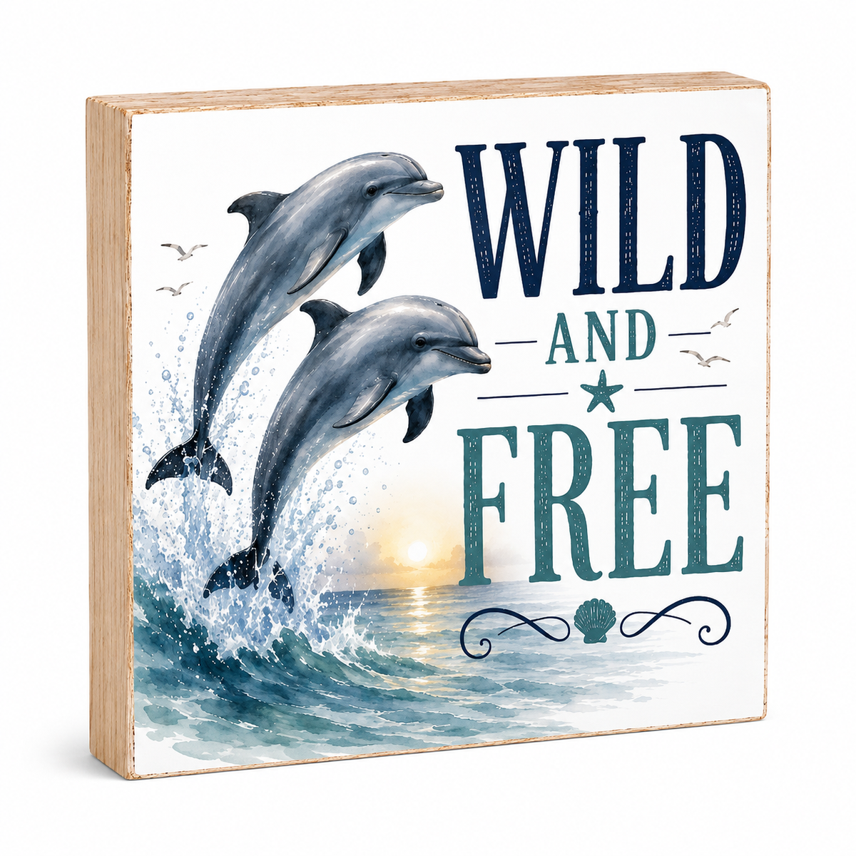 A square wooden decorative sign featuring two dolphins jumping from the ocean with the words “WILD AND FREE” in large navy and teal lettering, shown on a clean white background.