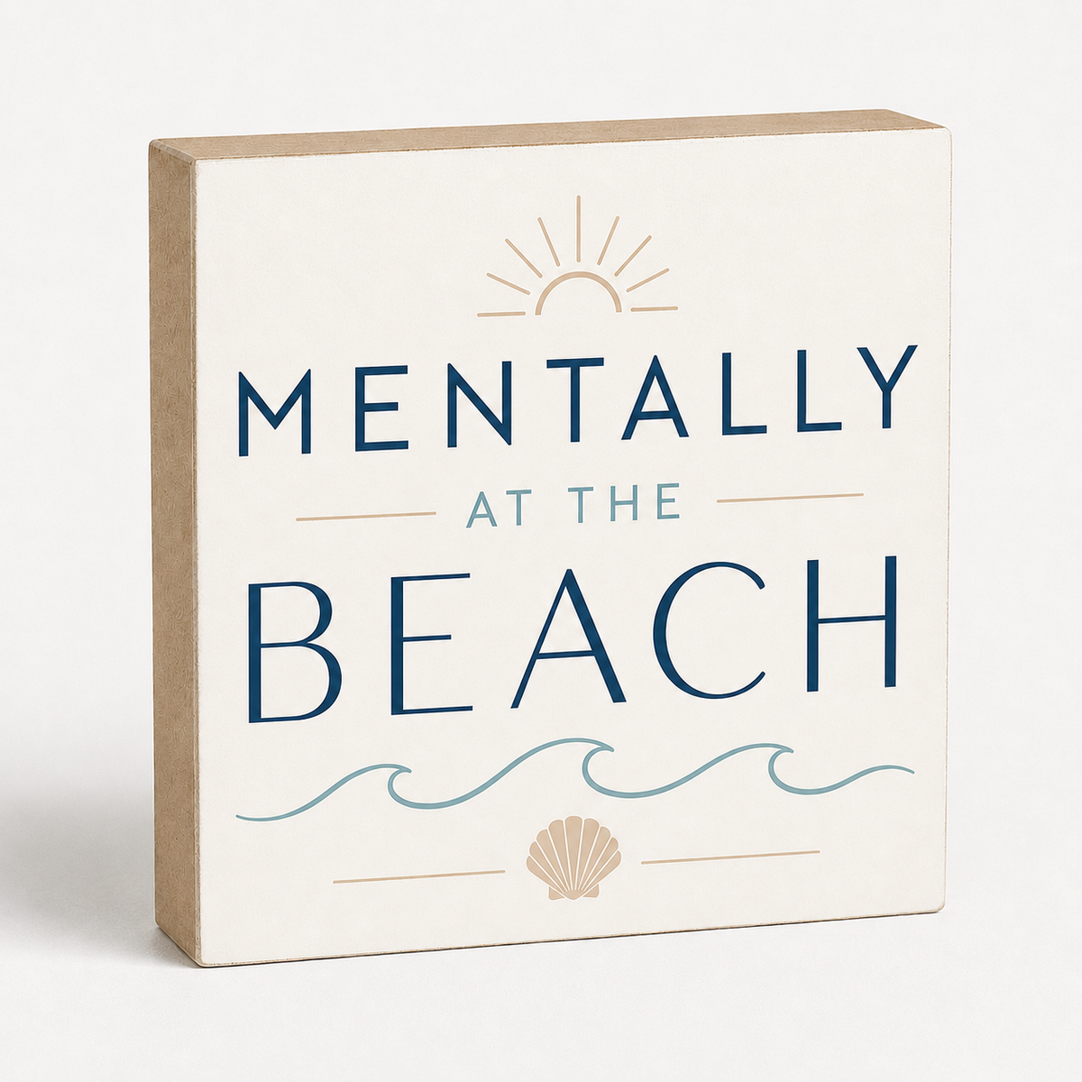 A square decorative wall sign with a natural wood edge and an off-white face that reads “MENTALLY AT THE BEACH” in navy and light blue lettering, with a sun, waves, and seashell illustration.