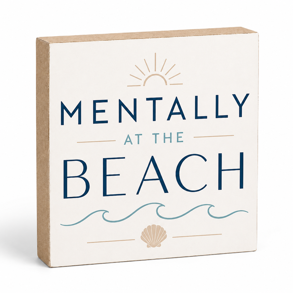A square decorative sign with a kraft paper side edge and a cream front panel that reads “MENTALLY AT THE BEACH” in navy and light blue lettering, with a sun, waves, and seashell illustration.