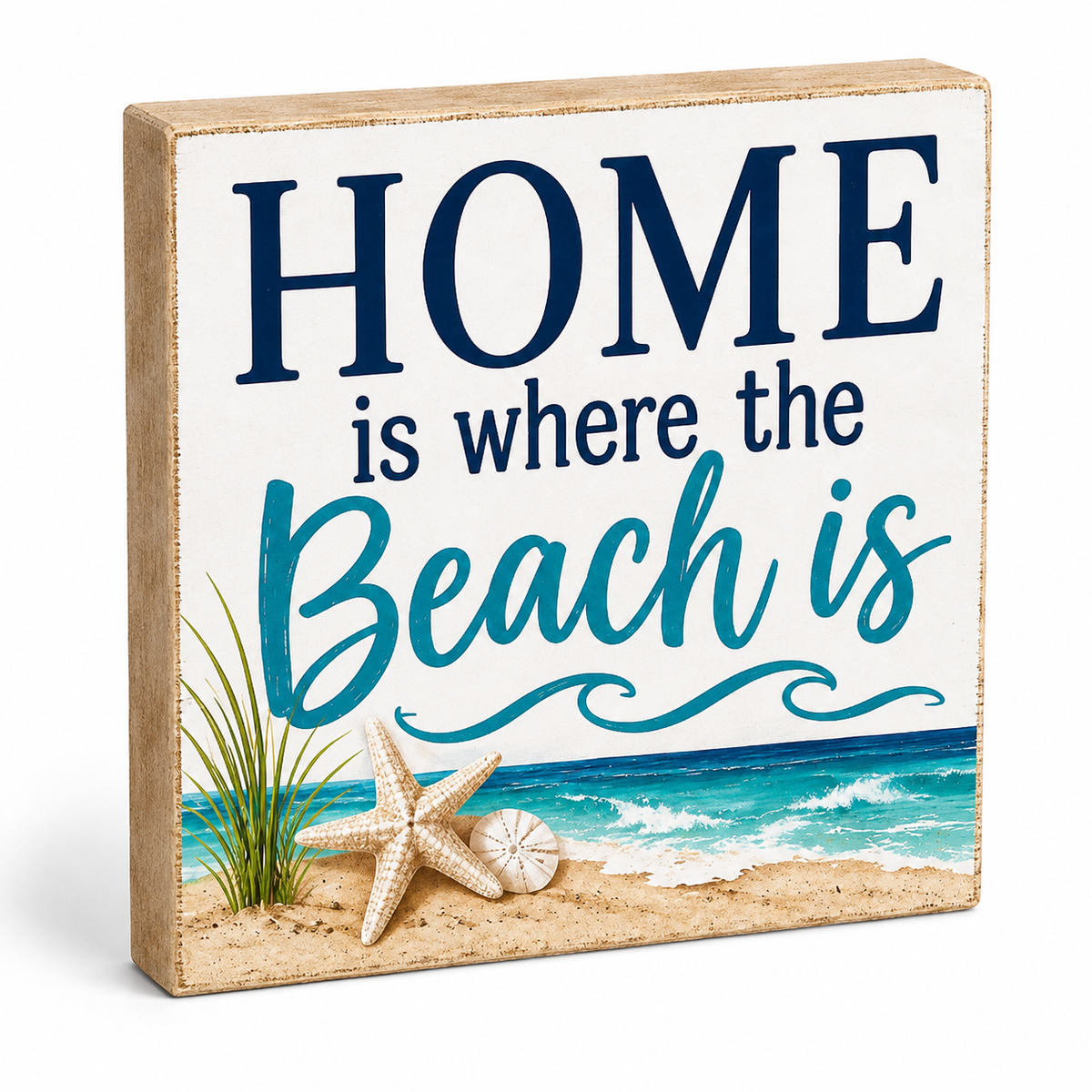 A square decorative wooden sign with a beach scene printed on the front. The sign reads “HOME is where the Beach is” in navy and teal lettering on a white background, with sand, ocean waves, grass, and starfish illustrations.