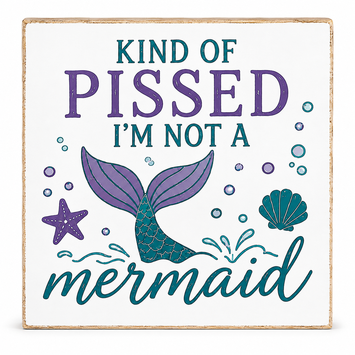 Square decorative wall sign with a distressed white face and natural wood edge. The sign features the text 'KIND OF PISSED I'M NOT A mermaid' in purple and teal lettering, with a purple and teal mermaid tail, starfish, bubbles, and shell illustration.