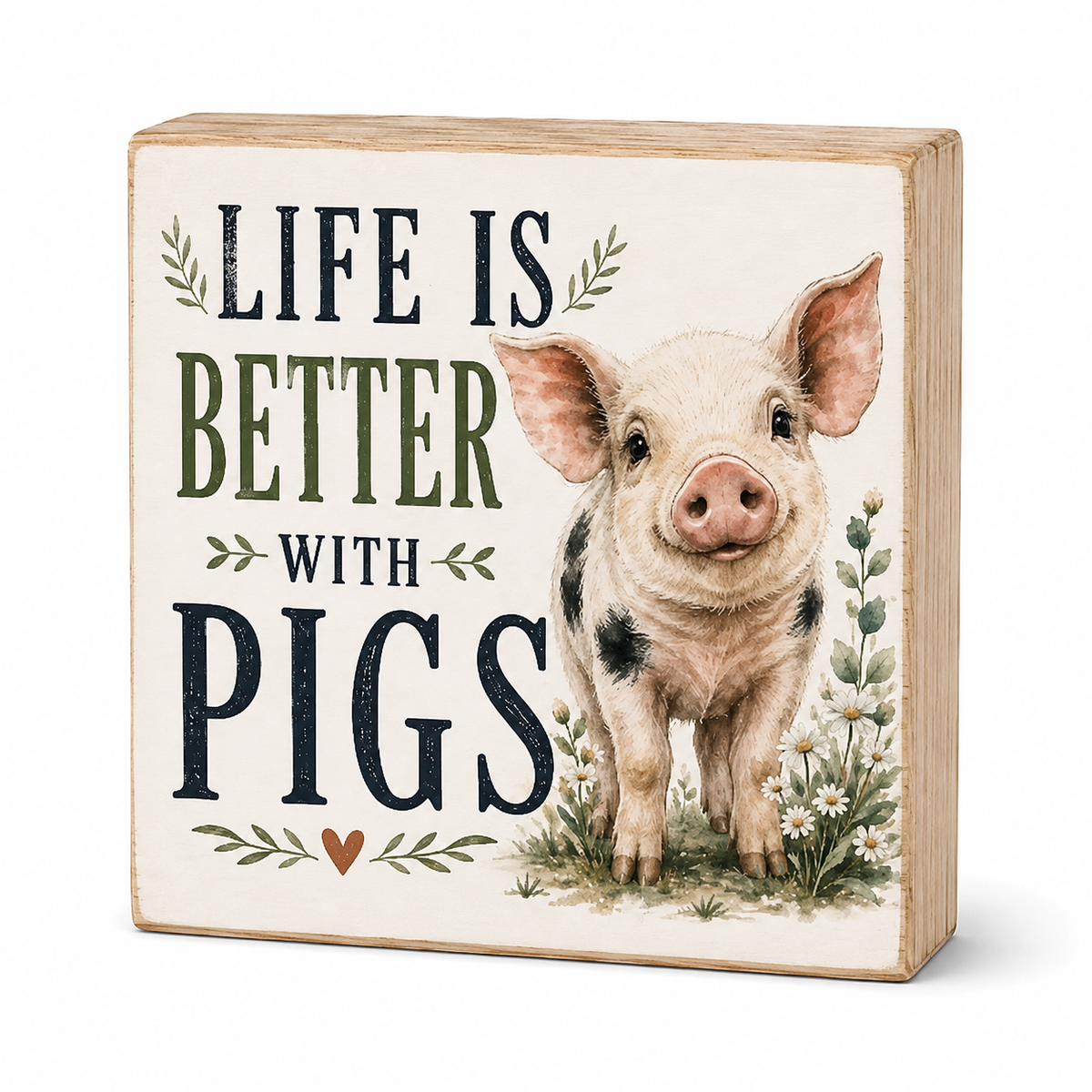 A square decorative wooden sign with a light natural wood edge and a cream face, featuring the phrase “LIFE IS BETTER WITH PIGS” in dark navy and olive lettering beside an illustrated pig standing among small flowers and leaves.
