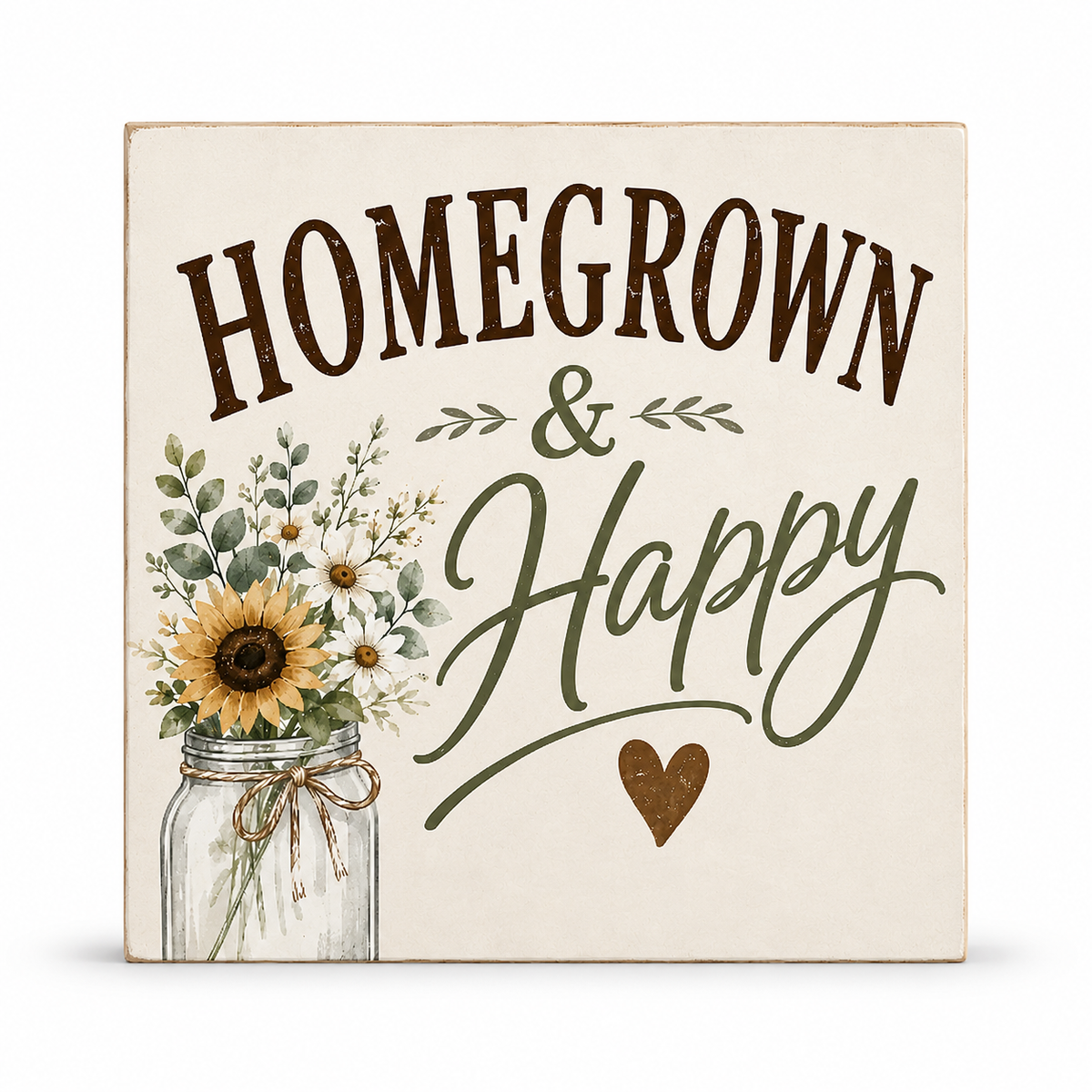 A square decorative wall sign with the words “HOMEGROWN & Happy” in brown and green lettering, featuring a sunflower and small floral arrangement in a mason jar on a cream background.