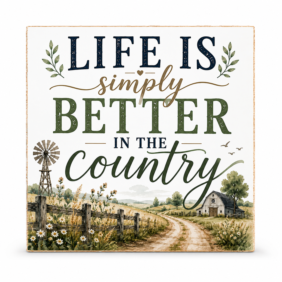 Square decorative wall sign with the phrase “LIFE IS simply BETTER IN THE country” in rustic lettering, plus a painted country scene with a windmill, fence, flowers, dirt road, and small barn. The sign is shown on a plain white background.