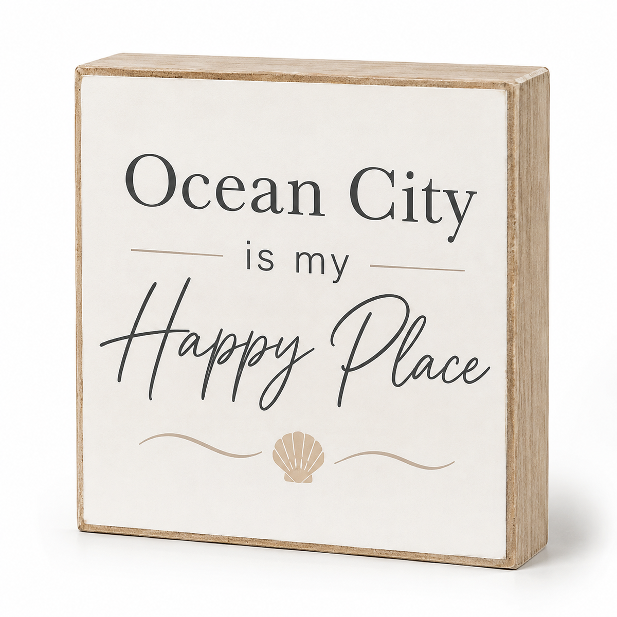 A square decorative wooden sign with a light natural wood frame and a cream face. The sign features the text 'Ocean City is my Happy Place' in black lettering, with a small beige seashell illustration at the bottom, shown on a clean white background.