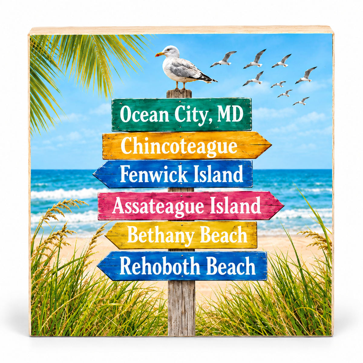 Square wooden plaque featuring a beach-themed signpost with colorful directional arrows reading Ocean City, MD, Chincoteague, Fenwick Island, Assateague Island, Bethany Beach, and Rehoboth Beach, with a seagull and ocean background.