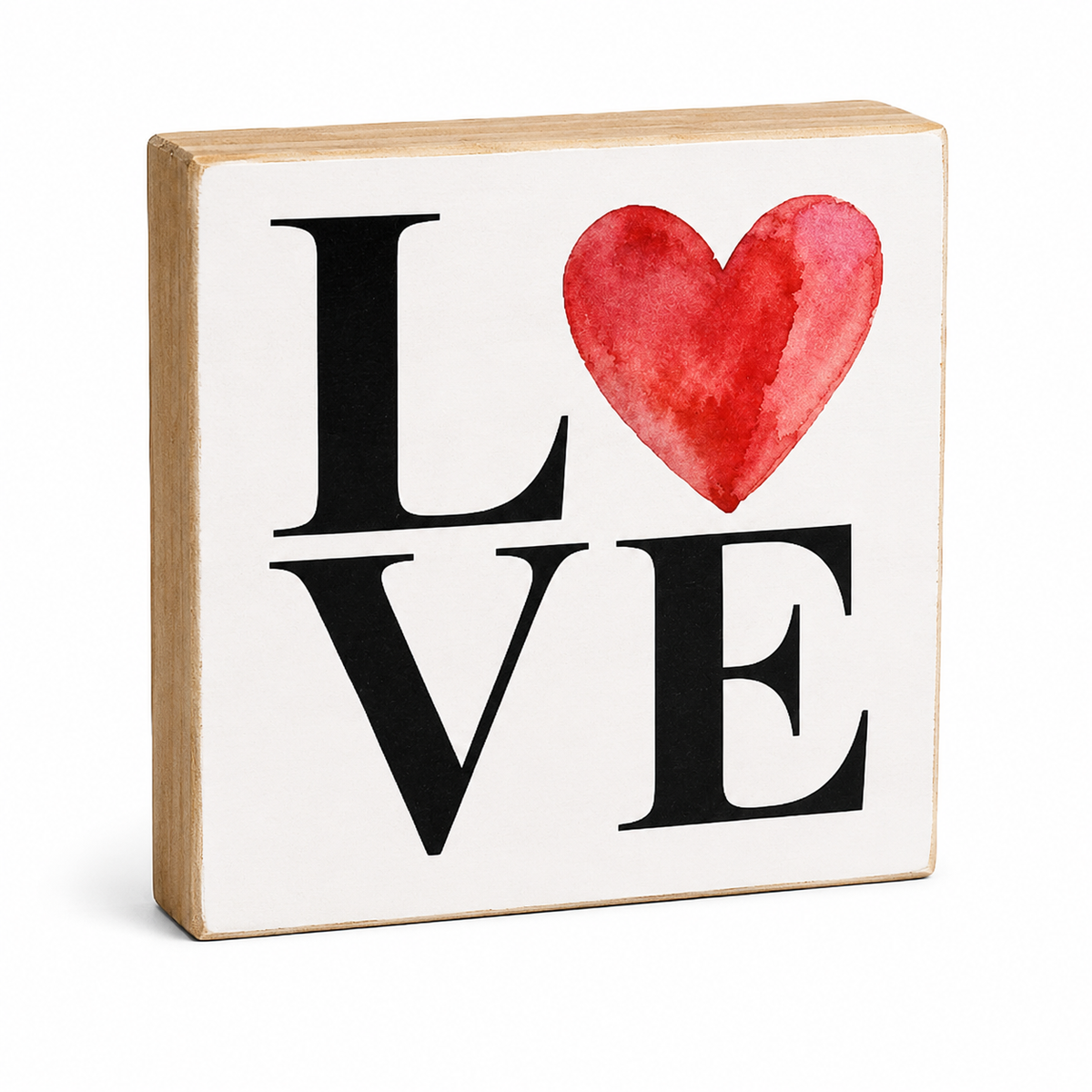 A square decorative wooden block sign with a white face, featuring the word 'LOVE' in black serif letters with a red watercolor heart replacing the 'O'. The natural wood edges are visible around the sign, which is photographed on a clean white background.