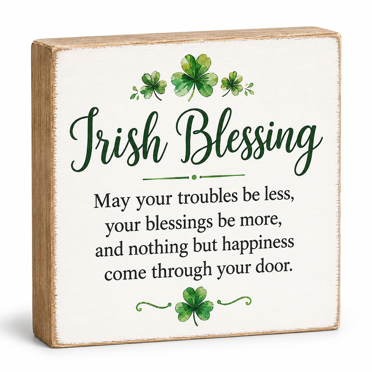 A square decorative wooden sign with a whitewashed face and natural wood edges. The sign reads 'Irish Blessing' in dark green script, with shamrock illustrations above and below, and a black text blessing below.