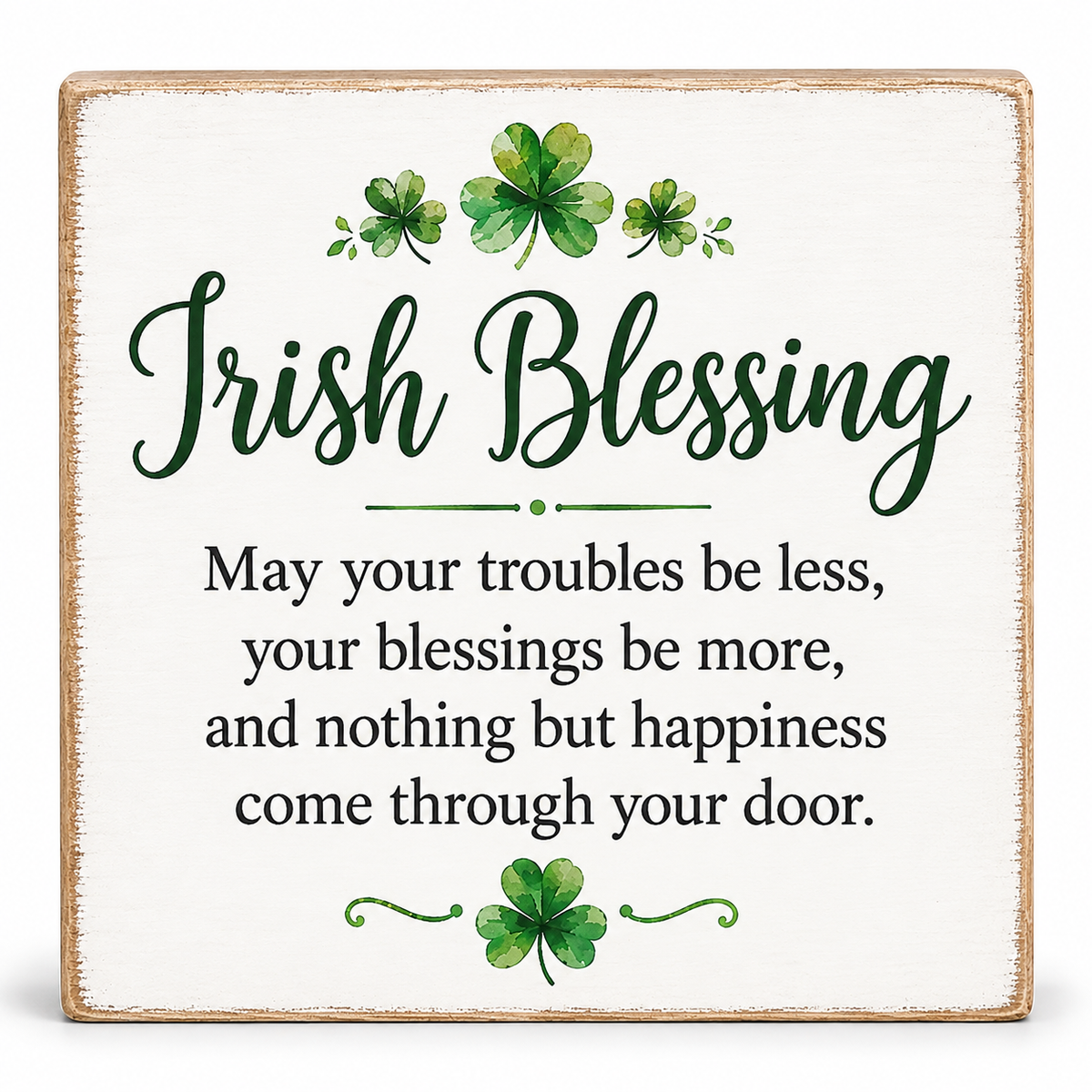 A square decorative sign with a distressed white background and natural wood edge, featuring the text 'Irish Blessing' in dark green script and a traditional blessing in black serif text. Watercolor green shamrocks decorate the top and bottom of the design.