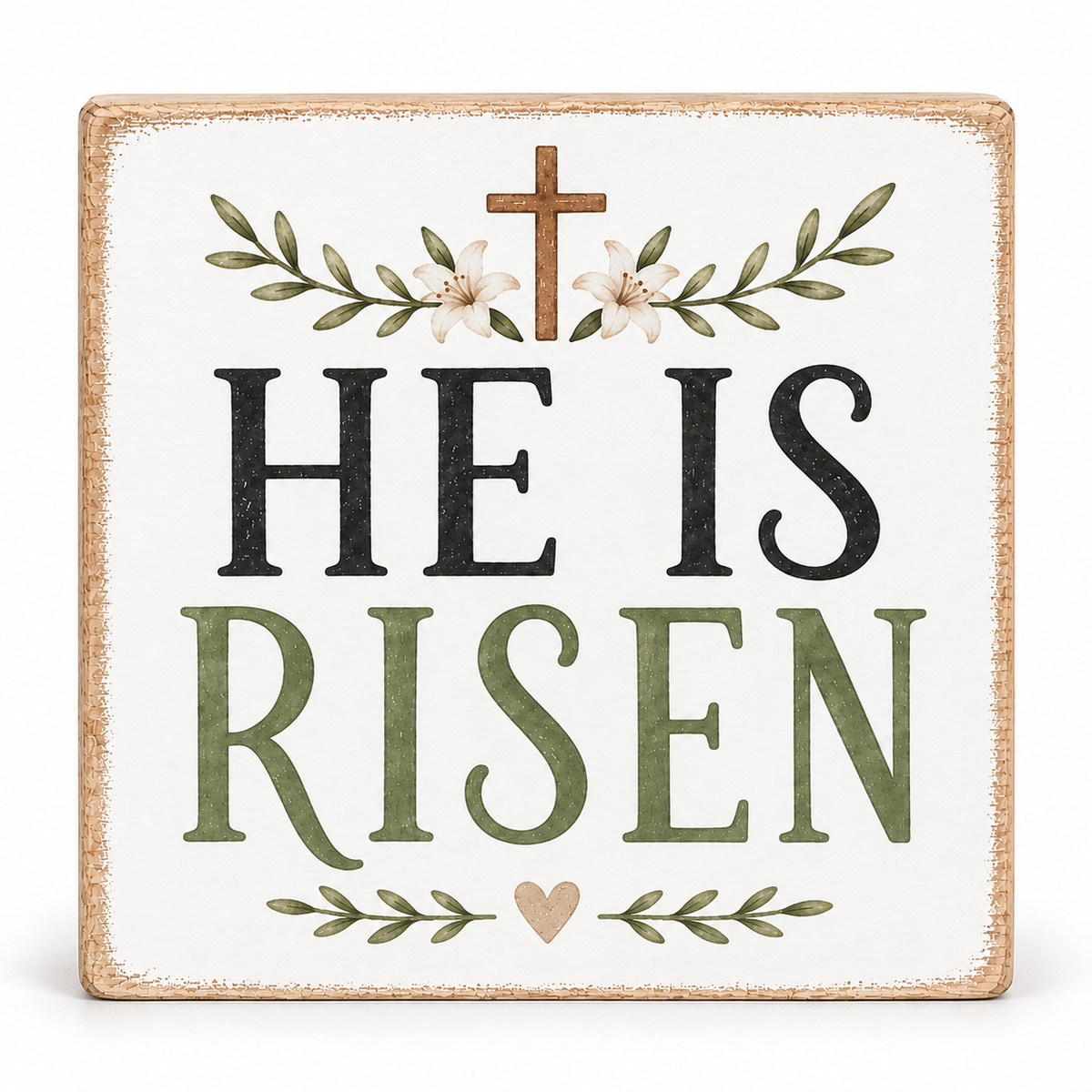 A square decorative sign with a distressed white background and rustic tan border. The text reads “HE IS RISEN” in large black and muted green letters, with a small brown cross above and leafy floral accents in green and cream.