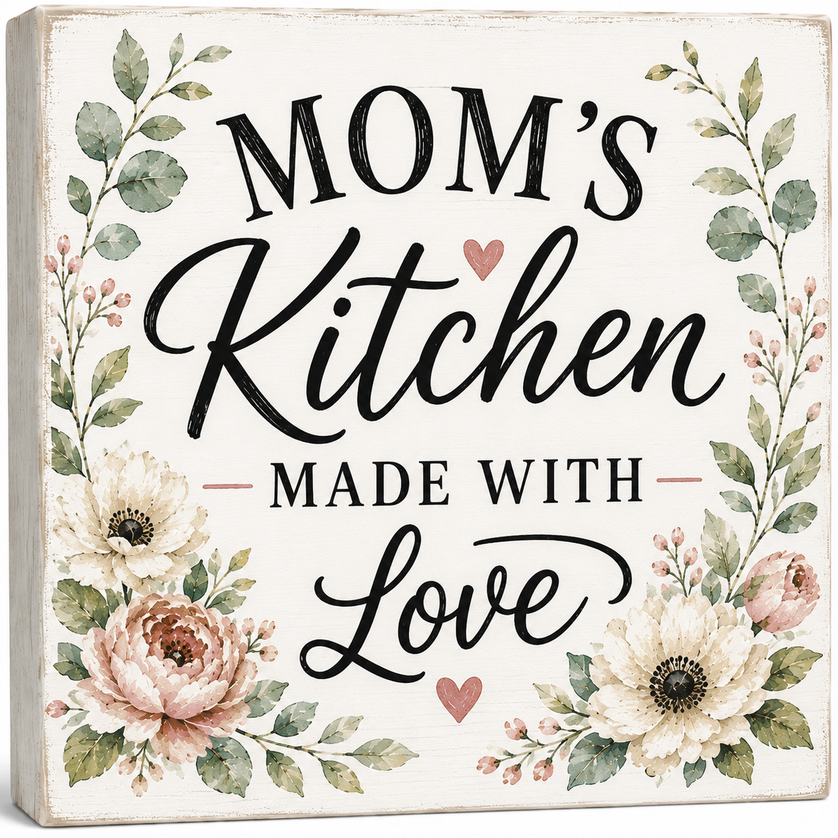 Decorative sign with floral designs and text 'Mom's Kitchen Made with Love' on a white background.