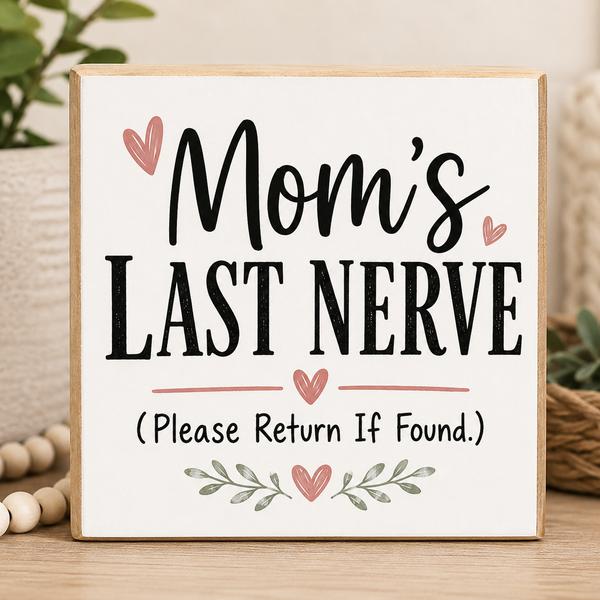 Decorative sign with text 'Mom's Last Nerve (Please Return If Found)' on a wooden surface.
