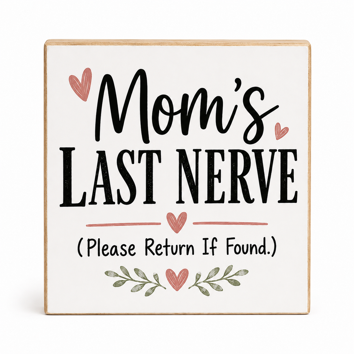 A square decorative wooden sign with a white face and natural wood edges, printed with the phrase 'Mom's Last Nerve (Please Return If Found.)' in black lettering with pink hearts and green leaf accents, shown on a light gray background.
