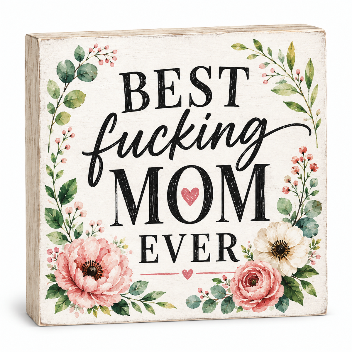 A square decorative wooden sign with the phrase “BEST fucking MOM EVER” in black lettering, surrounded by pink and cream flowers and green leaves on a white background.