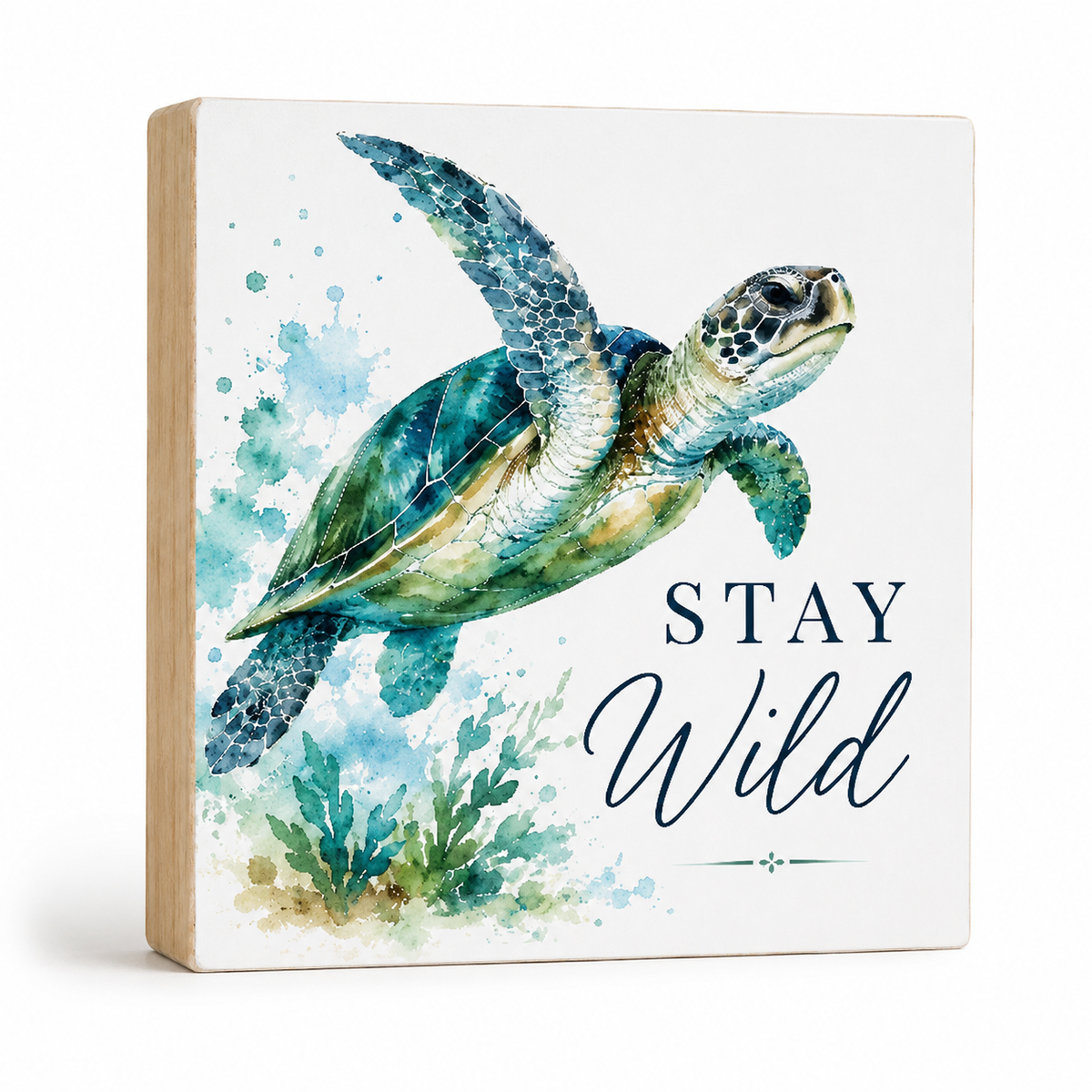 Square wooden wall sign featuring a watercolor sea turtle illustration, blue watercolor splashes, and the words “STAY Wild” on a white front panel with a natural wood side edge, shown on a light gray background.