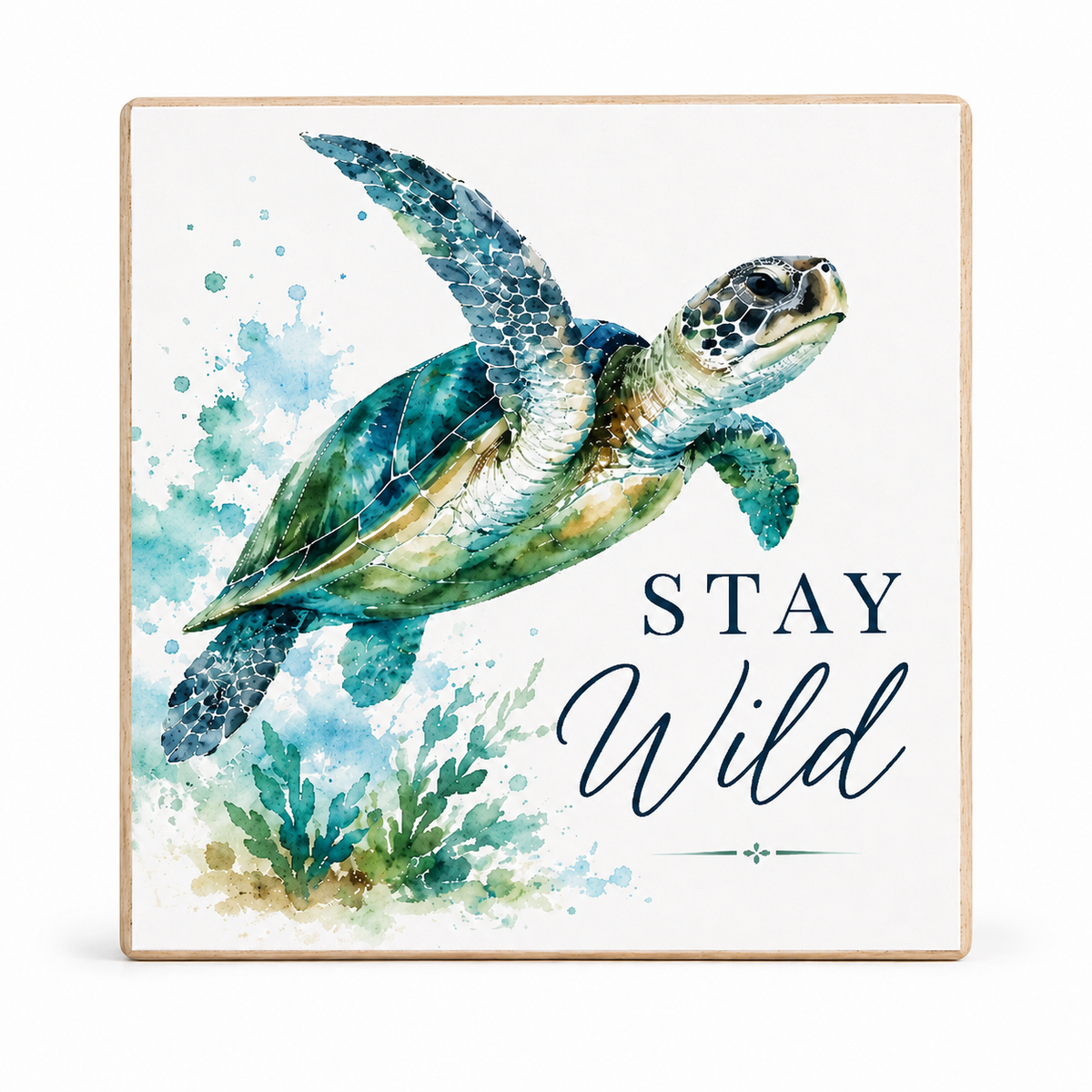 Square decorative wall sign with a watercolor sea turtle illustration, blue watercolor splashes, coral-like green plants, and the words “STAY Wild” on a white background with a light wood border.