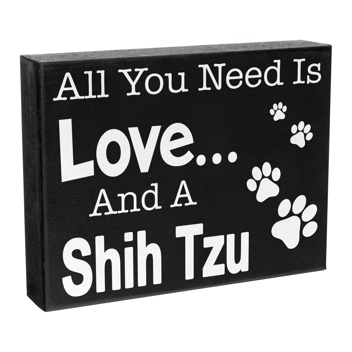 A black wooden box sign with the text 'All You Need is Love... A Shih Tzu' and paw prints design.