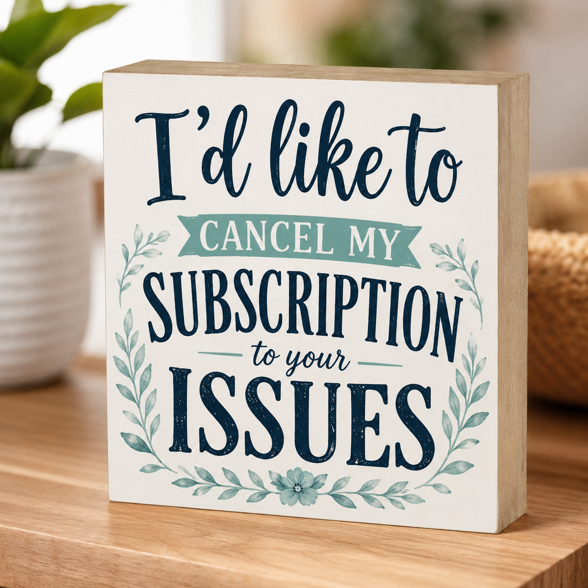Decorative sign with text 'I'd like to cancel my subscription to your issues' on a wooden surface.