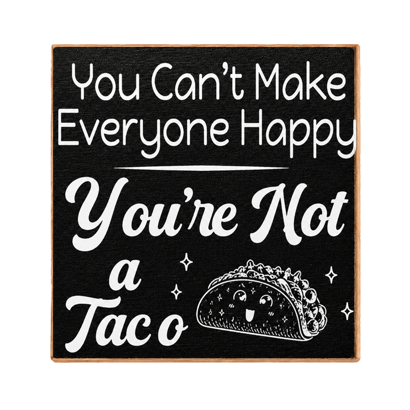 A square black decorative sign with a light wood border, featuring white text that reads 'You Can't Make Everyone Happy You're Not a Taco' and a cartoon taco illustration with a smiling face.