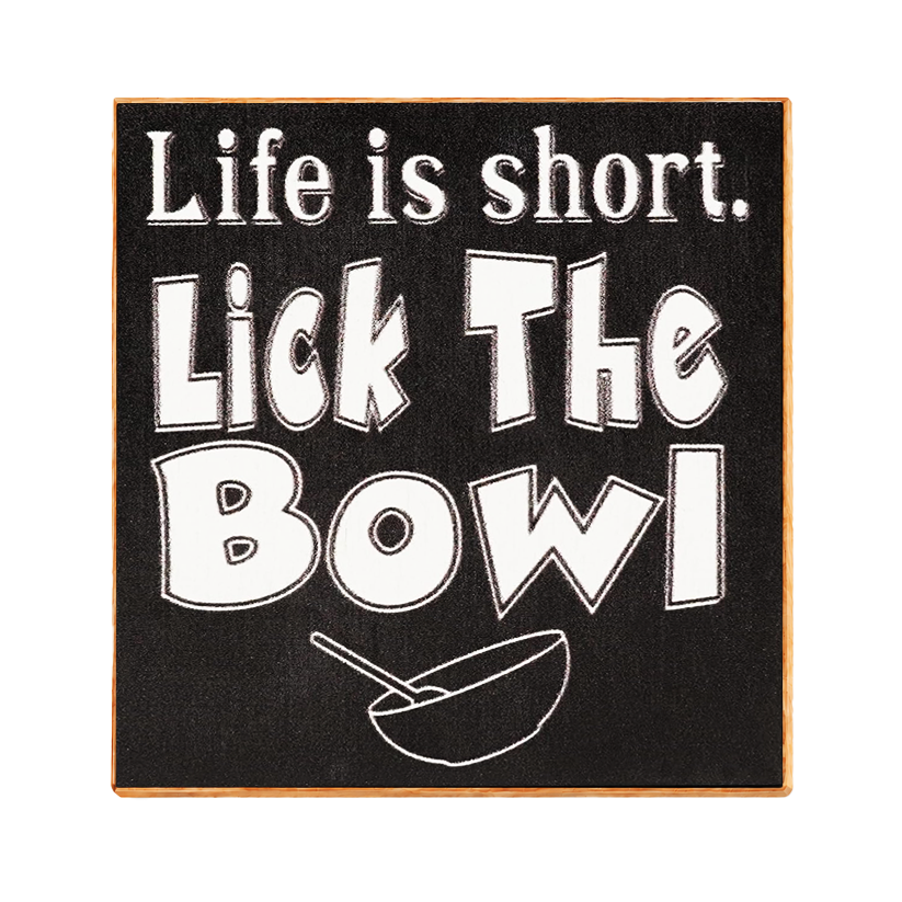 Square decorative sign with a black chalkboard-style background and a light wood border. White stylized text reads “Life is short.