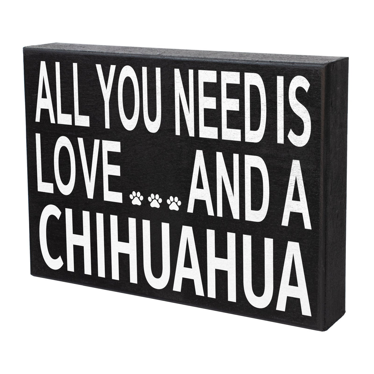 A rectangular black wooden sign with bold white text reading 'ALL YOU NEED IS LOVE.