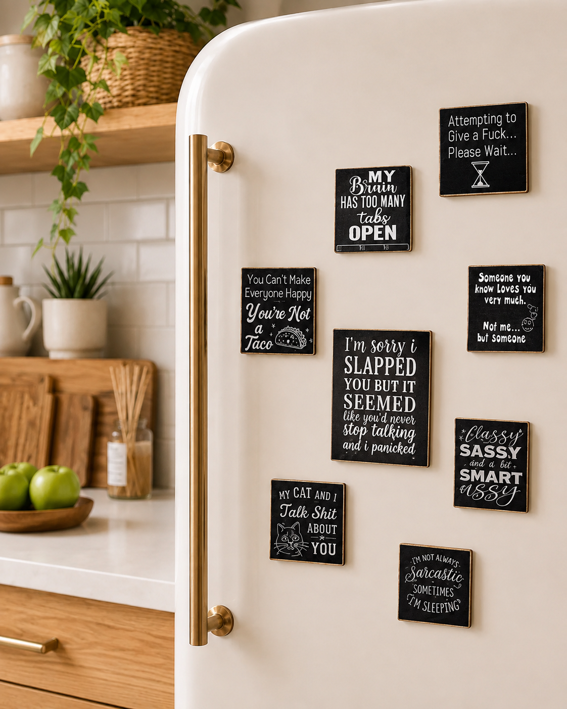 A cream refrigerator in a kitchen setting, decorated with multiple black square magnets featuring white hand-written style humorous and witty quotes.