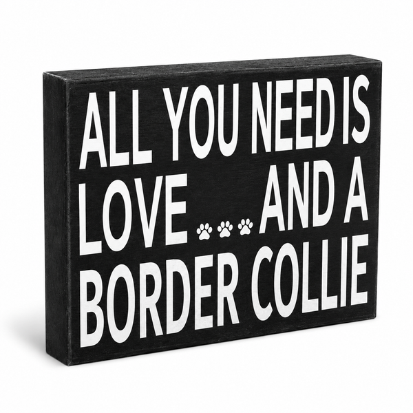 A rectangular black wooden sign with bold white text reading 'ALL YOU NEED IS LOVE.