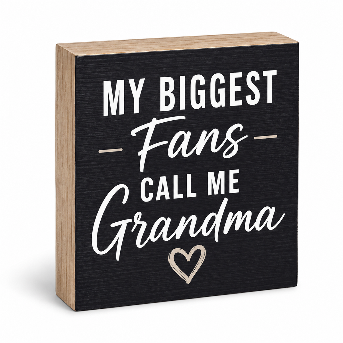 A square decorative wooden sign with a black front panel and natural wood sides, printed with the phrase “MY BIGGEST Fans CALL ME Grandma” in white lettering, plus a small outlined heart near the bottom, shown on a white background.